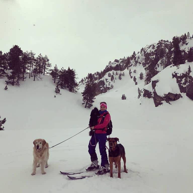 Chica esquiando con sus perros